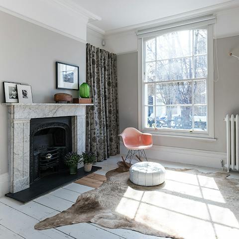 Reading by the fireplace on the Eames