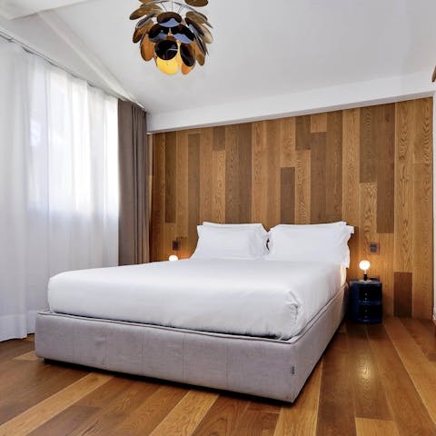 Feel cosy in the wood-panelled bedroom