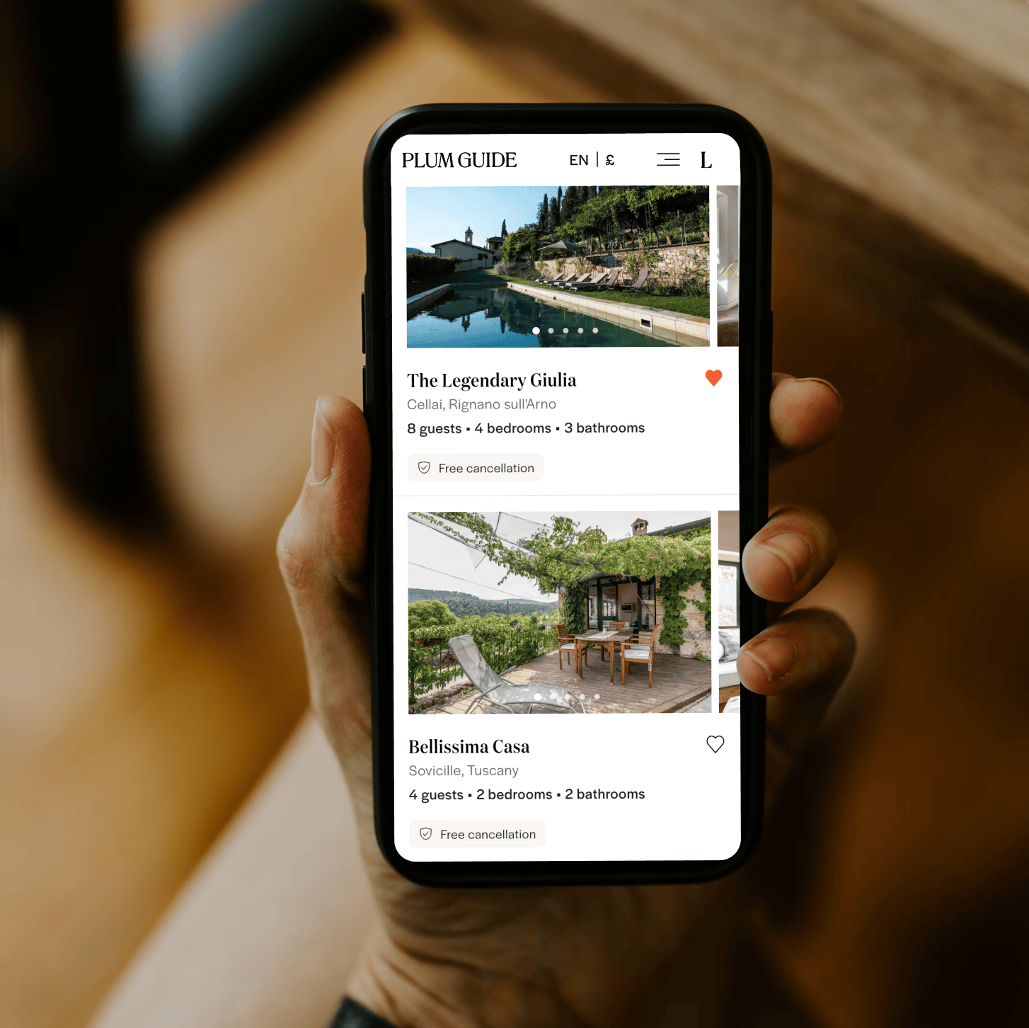 Holding a phone displaying Plum Guide cancellation details